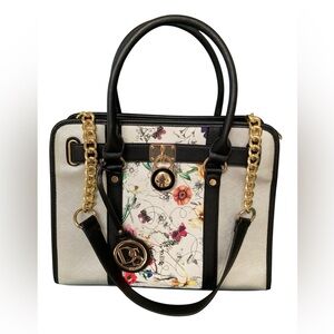 Dasein ladies handbag. Black with front floral panel. Gold tone hardware.